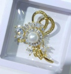 Brass flower brooch with clear cz stone paved in gold plating